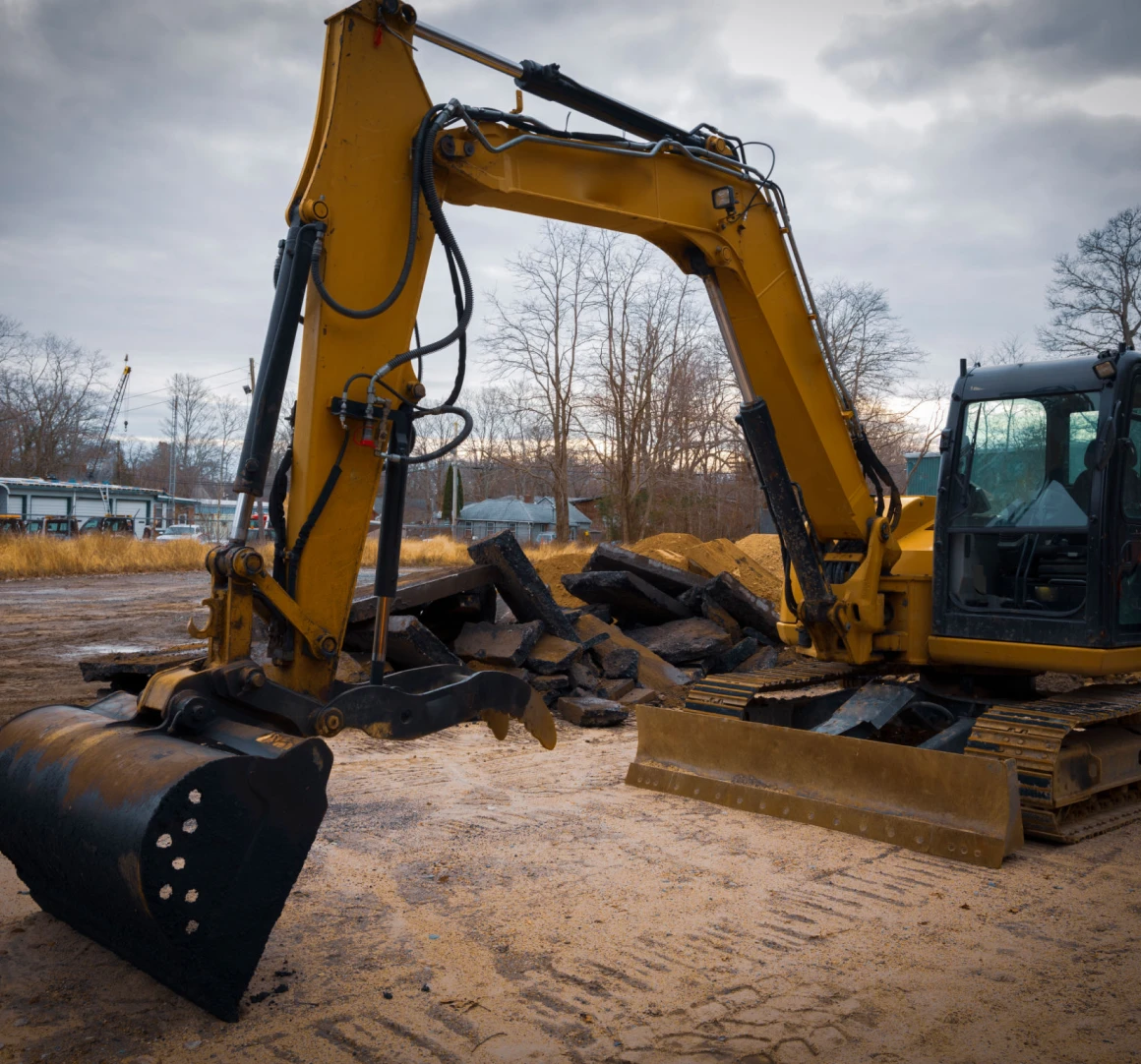 Excavator at construction site with debris